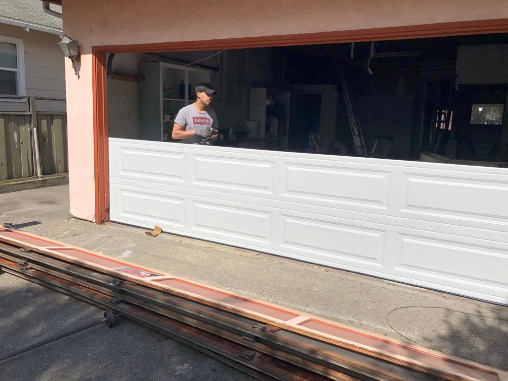 An expert technician changing the garage door