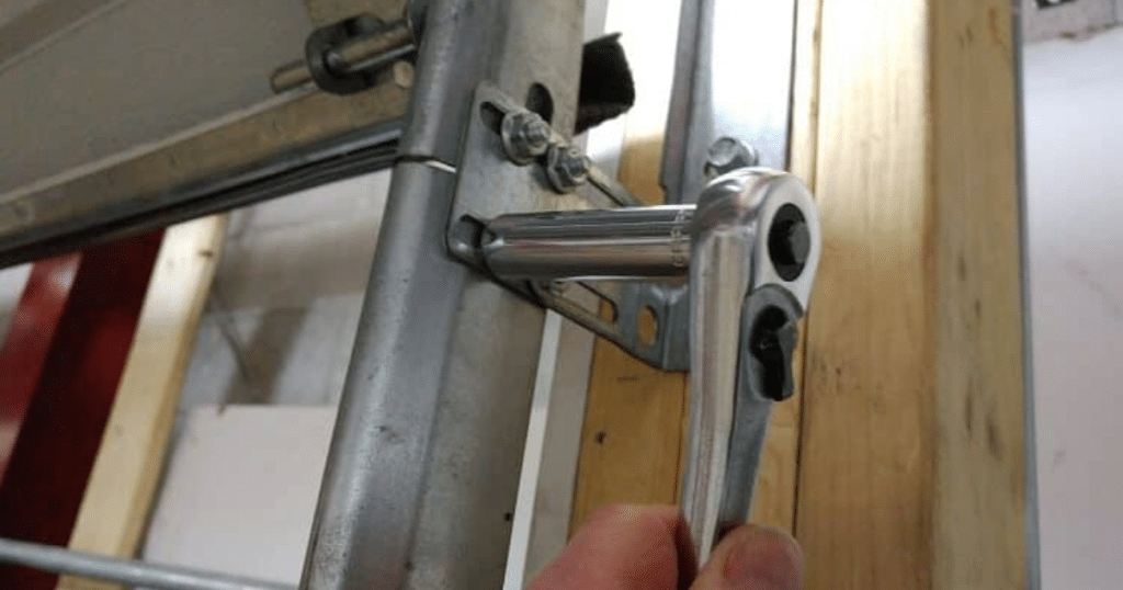 person repairing garage door wheel